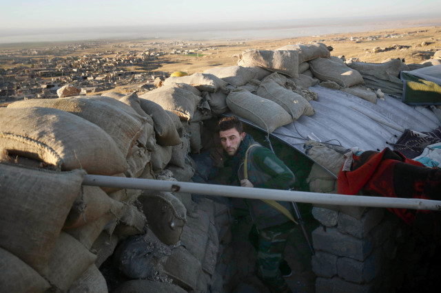 A Kurdish peshmerga fighter pauses during an operation to retake the northern Iraqi town of Sinjar on Thursday, Nov. 12, 2015 (AP) 