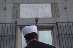 A representative of the Muslim community in Serbia stands in front of French embassy to pay his respects to the victims of the Paris attacks on Nov. 14, 2015 in Belgrade, Serbia,(Reuters)