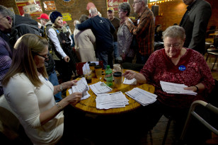 Volunteers sort through commitment to caucus for Democratic presidential candidate Hillary Clinton cards during a campaign event in Oskaloosa, Iowa on Jan. 25, 2016. (AP)