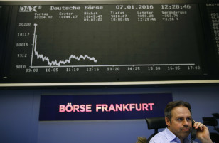 A trader speaks on a phone in front of the German share price index DAX board at  the stock exchange in Frankfurt on Jan. 7, 2016 (Reuters)