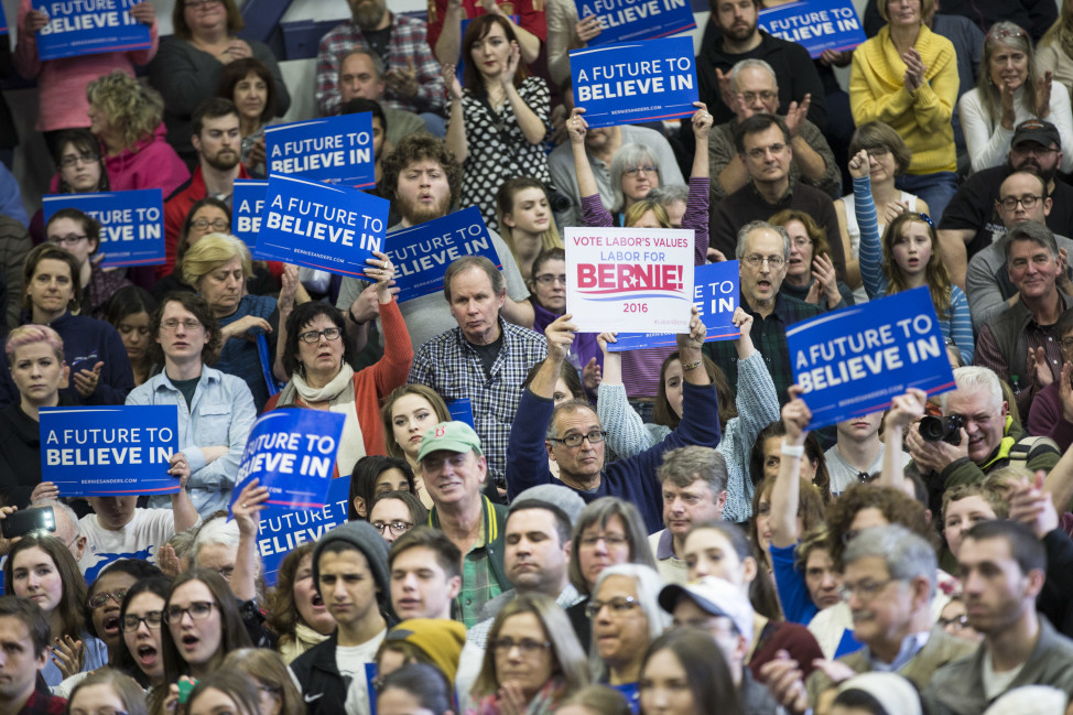 Supporters hold signs as Democratic presidential candidate Sen. Bernie Sanders, I-Vt., speaks during a campaign stop in Portsmouth, N.H. on Feb. 7, 2016. (AP)