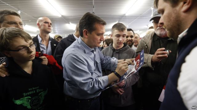 Republican presidential candidate, Sen. Ted Cruz, autographs a sign during a campaign event at the Johnson County Fairgrounds, Jan. 31, 2016 in Iowa City, Iowa.