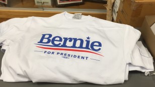 Stack of t-shirts available at a rally for Bernie Sanders in Des Moines, Iowa.  Jan. 31, 2016 (VOA-Muhammad Atif)  