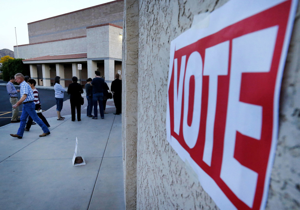 Arizonans arrive to vote and leave after casting their ballot in the state's presidential primary election, March 22, 2016, in Phoenix. (AP)