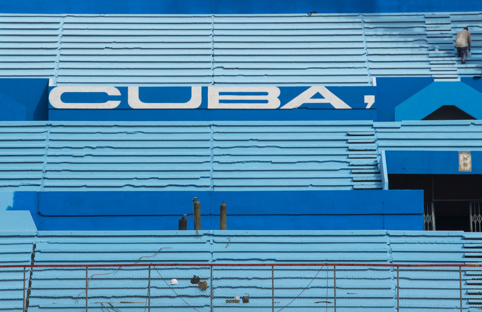 A worker paints the stands at the Latinoamericano Stadium baseball arena in Havana, Cuba in March. President Barack Obama plans to attend the Tampa Bay Rays' exhibition game at the arena on March 22 during his visit to Cuba. (AP)