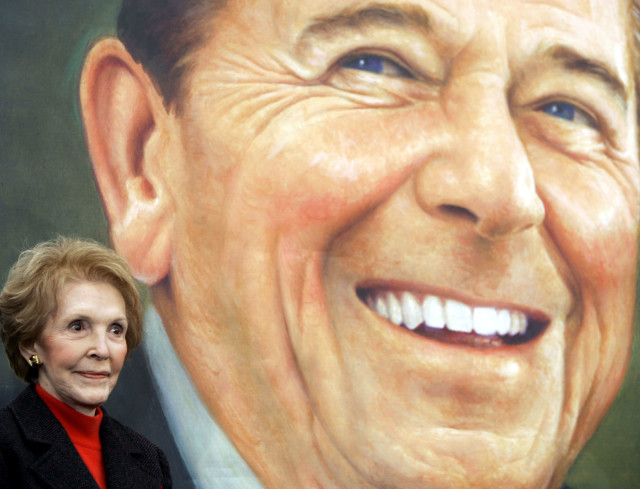 Former first lady Nancy Reagan stands nex to to an image of the President Ronald Reagan commemorative postage stamp during a ceremony at the Ronald Reagan Presidential Library and Museum November 9, 2004 in Simi Valley, California.  (Reuters)