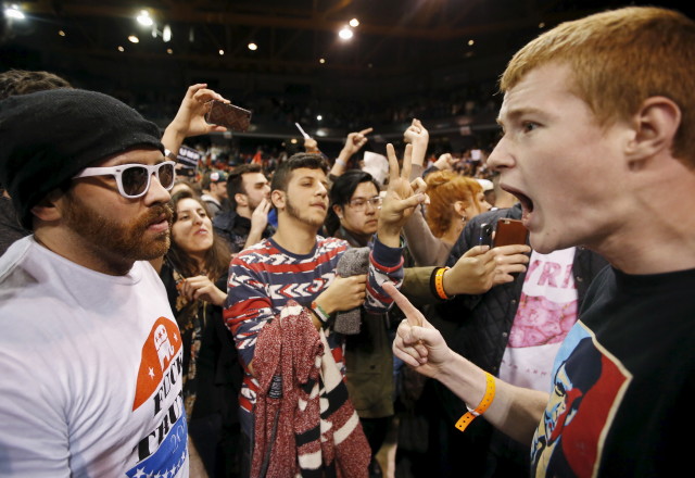 A Trump supporter (R) yells at a demonstrator (L) after Republican U.S. presidential candidate Donald Trump cancelled his rally at the University of Illinois at Chicago March 11, 2016. (Reuters) 