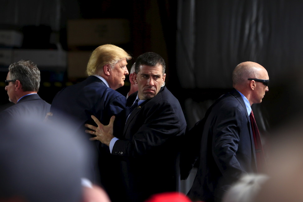 Secret Service agents surround U.S. Republican presidential candidate Donald Trump during a disturbance as he speaks at Dayton International Airport in Dayton, Ohio March 12, 2016.  (Reuters) 