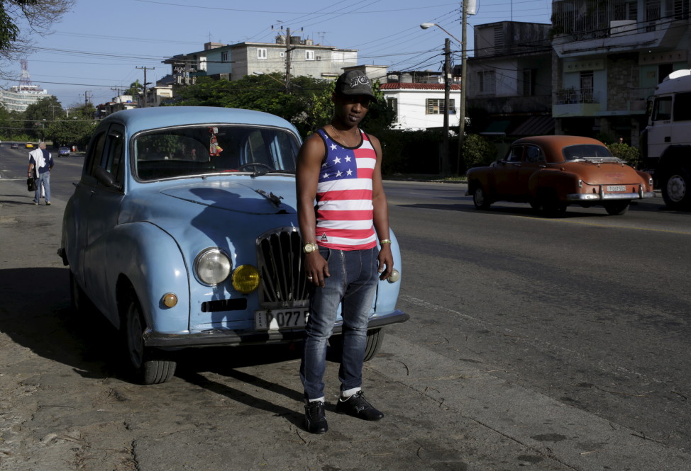 Yosuan, 26, wearing a shirt emblazoned with the American flag, stands on a street in Havana, Cuba on Feb. 22, 2016. (Reuters)