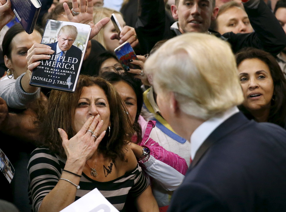 A woman blows a kiss to Republican presidential candidate Donald Trump (R) after Trump autographed her chest at his campaign rally in Virginia on Dec. 2, 2015. (Reuters)