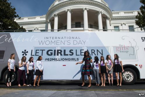 U.S. first lady Michelle Obama poses with young female students in front of the White House before an event to mark International Women's Day, as part of the first lady's Let Girls Learn initiative, in Washington, D.C., March 8, 2016.