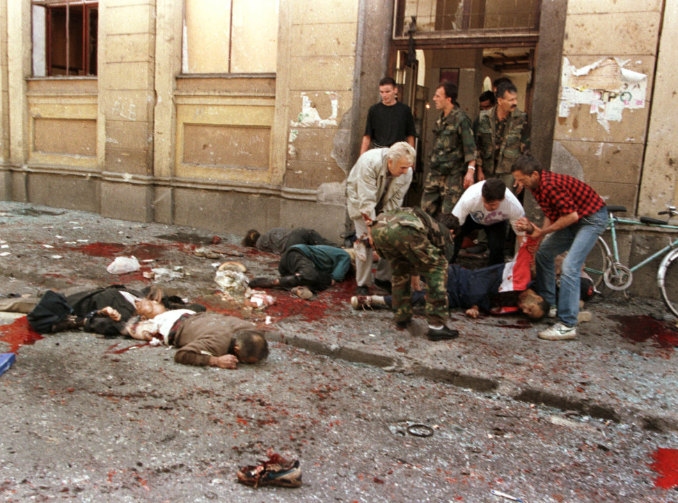 Gravely wounded civilians lie outside a Sarajevo market in center of the Bo...