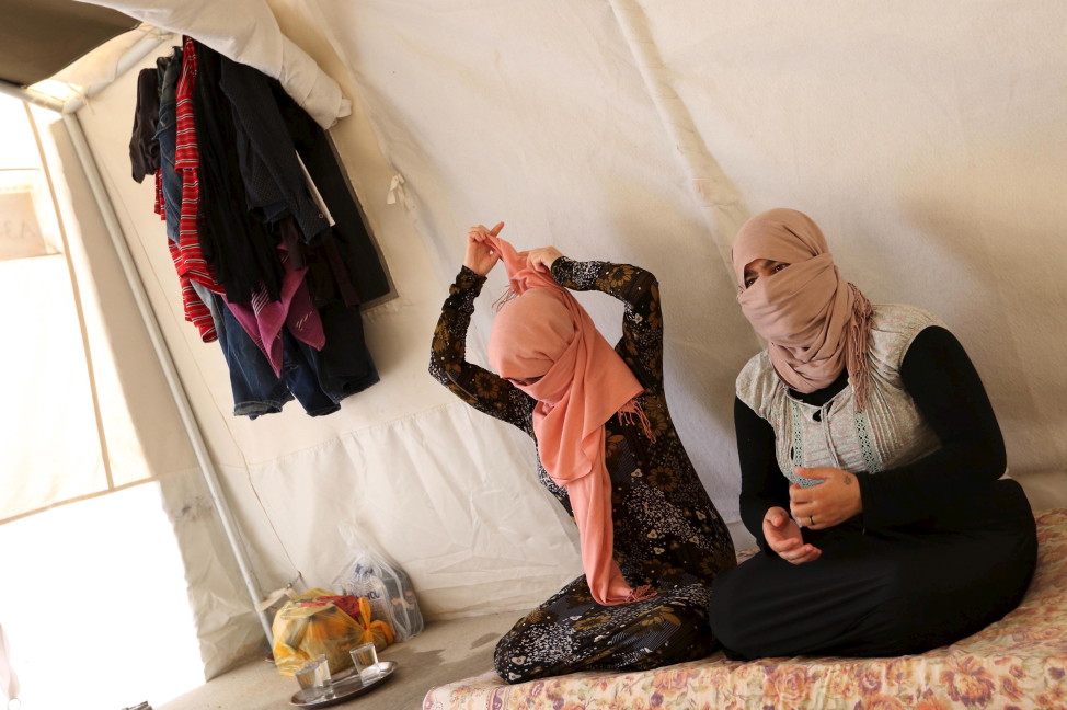 Yazidi sisters, who escaped from captivity by Islamic State militants, sit in a tent at Sharya refugee camp on the outskirts of Duhok province in Iraq on July 3, 2015. (Reuters)