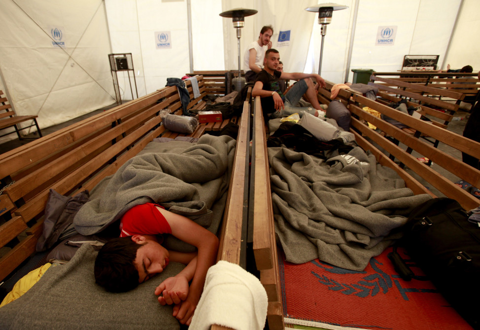 Syrian refugees rest on benches inside a tent at the transit center for refugees near southern Macedonia's town of Gevgelija, on the border with Greece on April 4, 2016.  (AP)