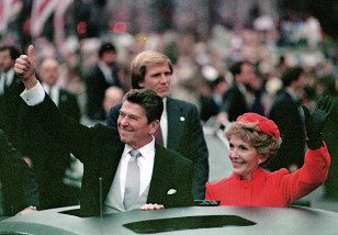 President Ronald Reagan plays to the crowd as his wife, First Lady Nancy Reagan, waves from limousine during the inaugural parade in this Jan. 20, 1981 file photo. (AP)