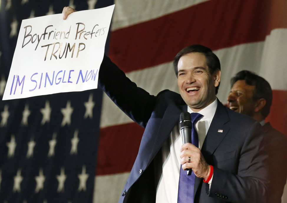 Republican presidential candidate, Sen. Marco Rubio, R-Fla., holds up an anti-Trump sign during a rally in Oklahoma City on Feb. 29, 2016. (AP)