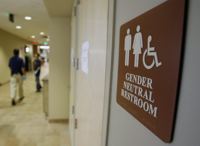 In this Aug. 23, 2007, file photo, a sign marks the entrance to a gender-neutral restroom at the University of Vermont in Burlington, Vt. Nearly all of the nation's 20 largest cities, including New York City, have local or state nondiscrimination laws that allow transgender people to use whatever bathroom they identify with, though a debate has raged around the topic nationwide, including North Carolina. (AP)