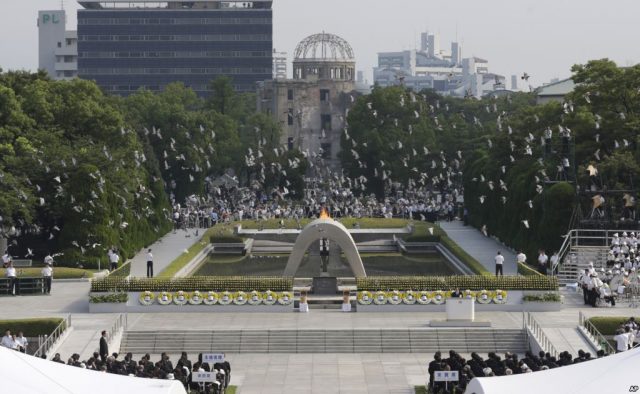 FILE - In this Aug. 6, 2013 file photo, doves fly over the cenotaph dedicated to the victims of the atomic bombing at the Hiroshima Peace Memorial Park during a ceremony marking the 68th anniversary of the bombing, in Hiroshima, western Japan.