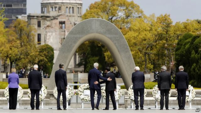 U.S. Secretary of State John Kerry, center left, puts his arm around Japan's Foreign Minister Fumio Kishida, center right, after they and fellow G7 foreign ministers laid wreaths at the cenotaph at Hiroshima Peace Memorial Park in Hiroshima, western Japan