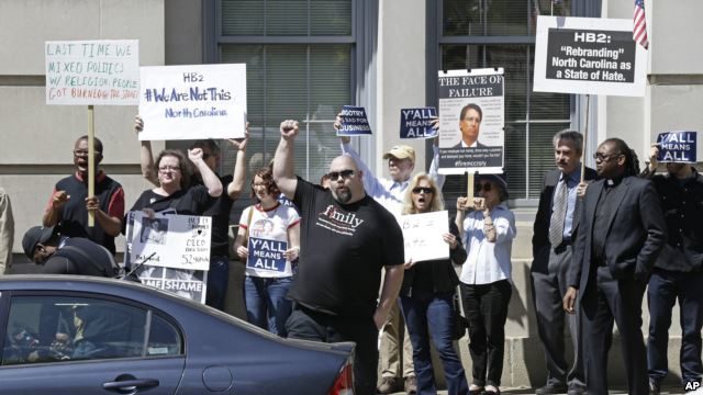 FILE - Opponents of House Bill 2 protest across the street from the North Carolina State Capitol in Raleigh, N.C., April 11, 2016.