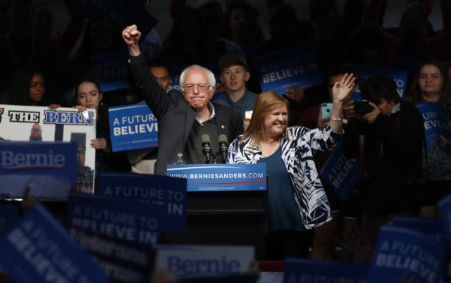 Democratic presidential candidate Sen. Bernie Sanders pumps his first in the air to the crowd after his wife Jane (R) came onstage and whispered in his ear as he spoke to supporters at a campaign event held during Indiana primary day at Waterfront Park in Louisville, Kentucky May 3, 2016. (Reuters)