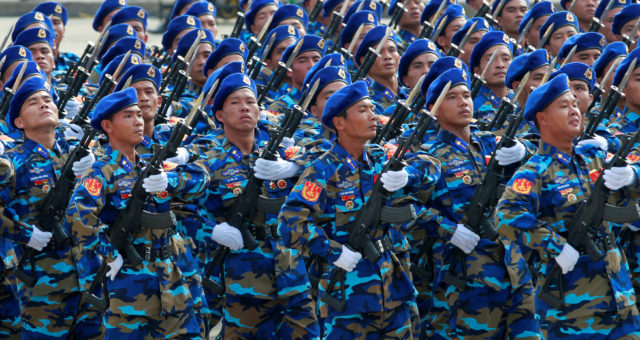 Vietnamese coast guard servicemen hold rifles while marching during a celebration to mark National Day in Hanoi, Vietnam September 2, 2015. Picture taken September 2, 2015. (Reuters) 