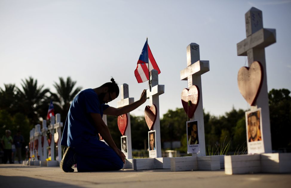 Ernesto Vergne prays at a cross honoring his friend Xavier Emmanuel Serrano Rosado and the other victims at a memorial to those killed in the Pulse nightclub mass shooting a few blocks from the club early Friday, June 17, 2016, in Orlando, Fla. (AP)