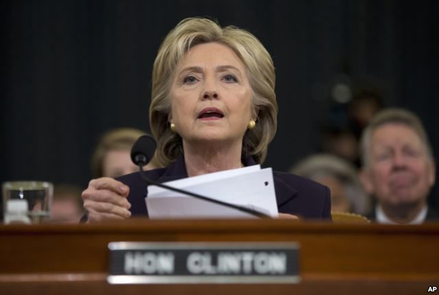 Democratic presidential candidate, former Secretary of State Hillary Rodham Clinton looks toward the dais as she settles into her seat prior to testifying before the House Benghazi Committee, on Capitol Hill in Washington, Oct. 22, 2015.