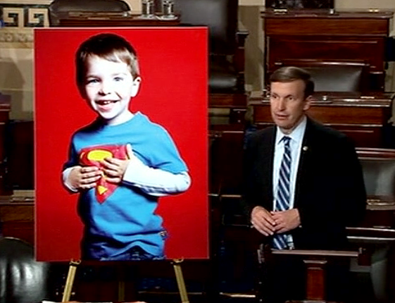 Sen. Chris Murphy (D-Connecticut) filibusters on the Senate floor about gun violence and urging action on gun control measures. He uses an image of six-year old Dylan Hockley who was gunned down during the 2012 mass shooting at Sandy Hook Elementary School. (Screen grab from Senate TV)  