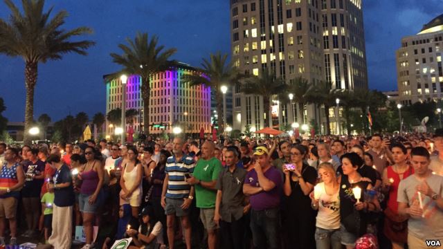 People gather outside the Dr Phillips Center for Performing Art in Orlando for a vigil for the victims and the injured of Orlando nightclub shooting. (S. Dizayee/VOA)