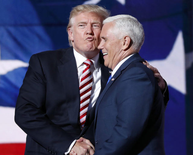 Republican presidential Candidate Donald Trump gives his running mate, Republican vice presidential nominee Gov. Mike Pence of Indiana a kiss as they shake hands after Pence's acceptance speech during the third day session of the Republican National Convention in Cleveland, Wednesday, July 20, 2016. (AP)