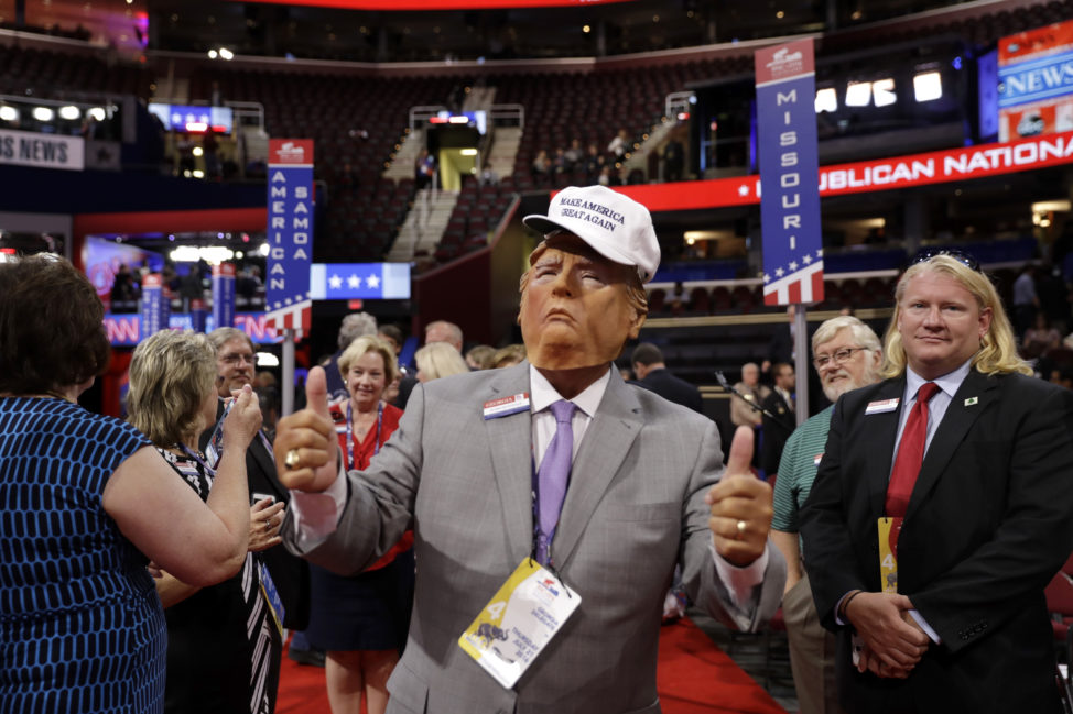 Georgia delegate Bubba McDonald poses for picture as he wears a mask of Republican Presidential Candidate Donald Trump before the final day of the Republican National Convention in Cleveland, Thursday, July 21, 2016. (AP) 