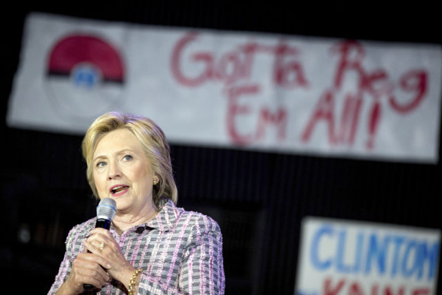 Hillary Clinton speaks to volunteers at a Democratic party organizing event at the Neighborhood Theater in Charlotte, N.C. A Pokemon poster is visible behind her. July 25, 2016. (AP) 