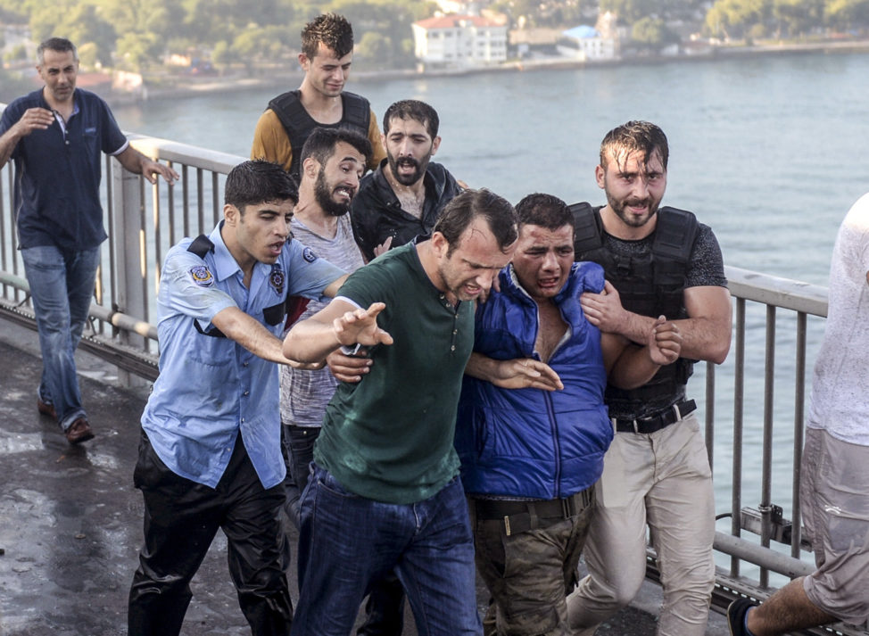 People apprehend a Turkish soldier that participated in the attempted coup, on Istanbul's Bosporus Bridge, Saturday, July 16, 2016.  (AP) 