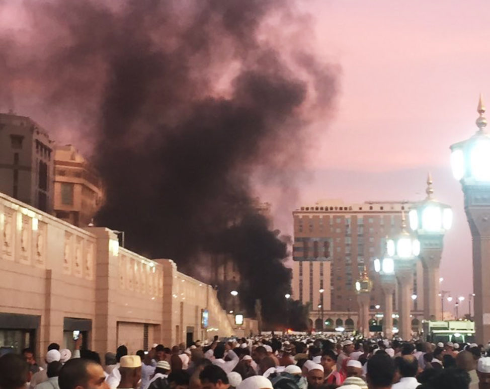 People stand by an explosion site in Medina, Saudi Arabia, July 4, 2016. (Courtesy of Noor Punasiya via AP)