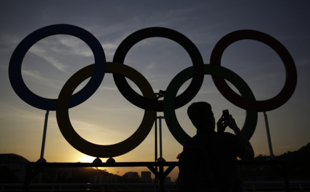 A man photographs the Olympic rings outside of Maracana Stadium ahead of the opening ceremony for the 2016 Summer Olympics in Rio de Janeiro, Brazil, Friday, Aug. 5, 2016. (AP) 