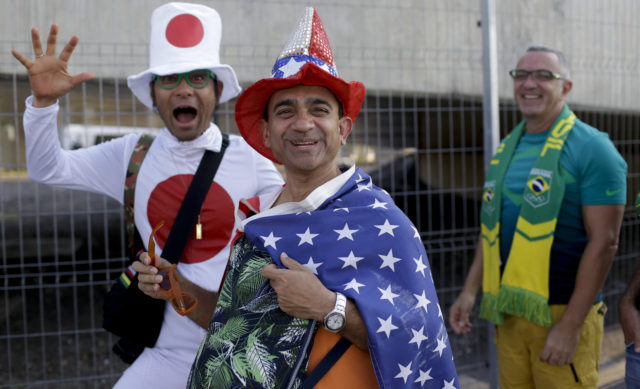Fans from Japan, United States, and Brazil, from right to left, walk towards the Maracana Stadium ahead of the opening ceremony for the 2016 Summer Olympics in Rio de Janeiro, Brazil, Aug. 5, 2016. (AP) 