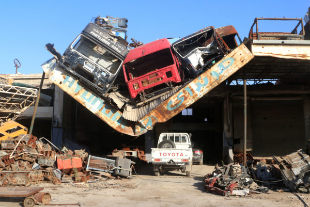 Damaged vehicles pile on a damaged roof of a car mechanic service center in Ramousah area southwest of Aleppo, Syria August 2, 2016. Picture taken August 2, 2016. (Reuters) 