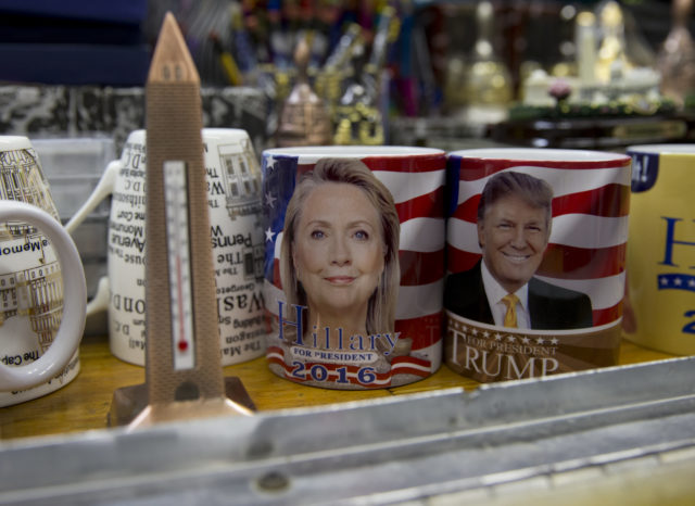 Coffee mugs for sale with the images of Democratic presidential candidate Hillary Clinton and Republican presidential candidate Donald Trump sit side by side on a shelf of a souvenir stand in Washington, Tuesday, Feb. 16, 2016. (AP) 