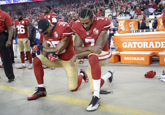 San Francisco 49ers safety Eric Reid (35) and quarterback Colin Kaepernick (7) kneel during the national anthem before an NFL football game against the Los Angeles Rams in Santa Clara, Calif., Sept. 12, 2016. (AP)