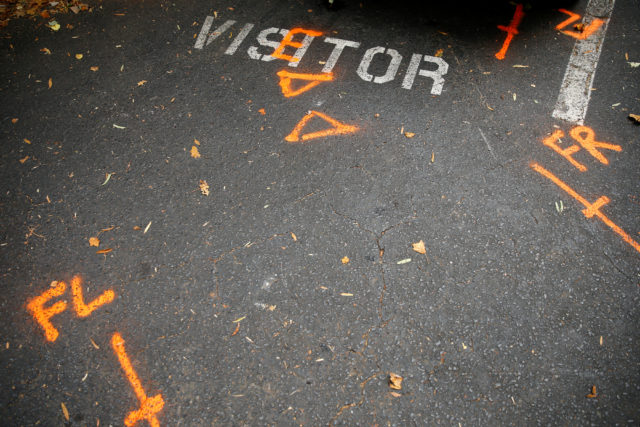 Orange spray paint used by police investigators is seen at a parking spot at The Village at College Downs apartment complex the morning after the police shooting of Keith Scott, in Charlotte, North Carolina, Sept. 21, 2016. (Reuters) 