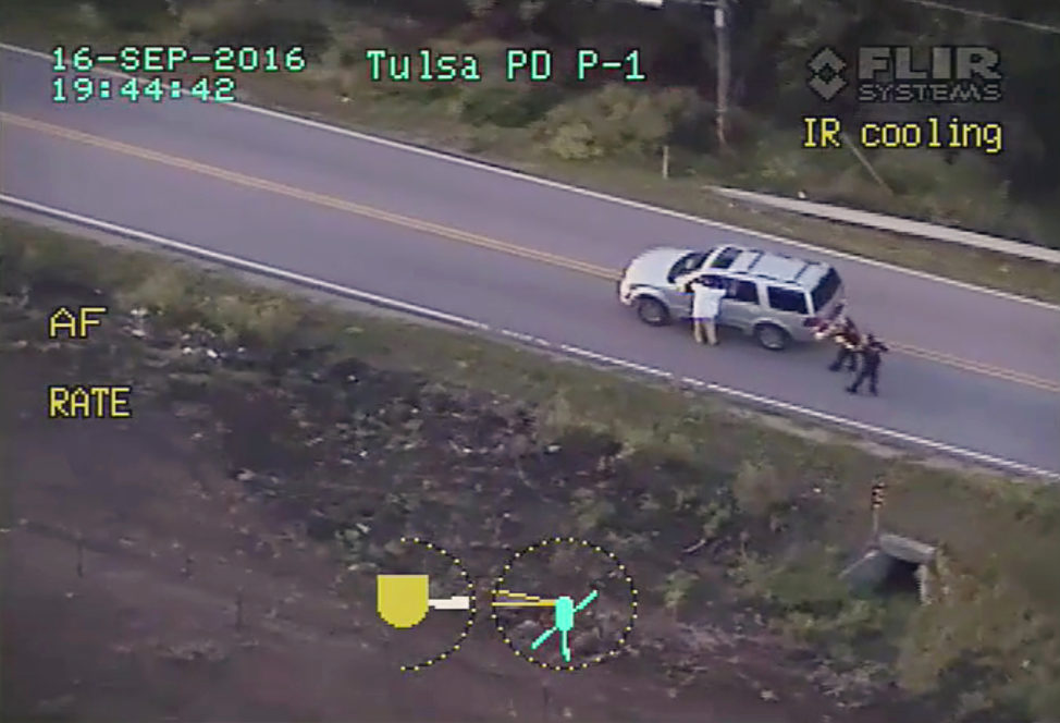 In this photo made from a Sept. 16, 2016 police video, Terence Crutcher, left, with his arms up is pursued by police officers as he walks next to his stalled SUV moments before he was shot and killed by one of the officers in Tulsa, Okla. Officer Betty Shelby was charged with felony manslaughter for firing the shots that killed Crutcher. She was released after posting $50,000 bond. (AP) 