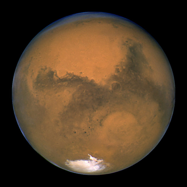 This Aug. 26, 2003 image made available by NASA shows Mars as it lines up with the Sun and the Earth. Photographed by the Hubble Space Telescope, it was about 55.8 million kilometers (34.6 million miles) from Earth. (NASA/J. Bell - Cornell U./M. Wolff - SSI via AP)