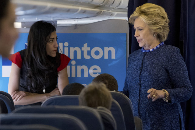 In this Oct. 28, 2016 file photo, Democratic presidential candidate Hillary Clinton speaks with senior aide Huma Abedin aboard her campaign plane at Westchester County Airport in White Plains. The longtime Hillary Clinton aide at the center of a renewed FBI email investigation testified under oath four months ago she never deleted old emails, despite promising in 2013 not to take sensitive files when she left the State Department. (AP)