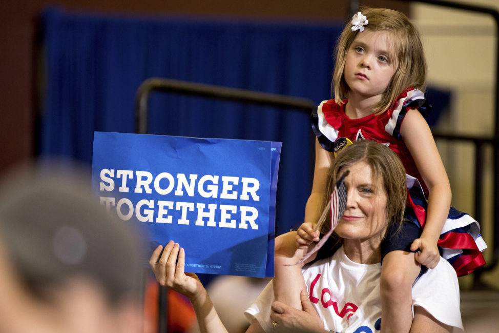 A girl and a woman's shoulders as Democratic presidential candidate Hillary Clinton speaks at a rally at Abraham Lincoln High School, in Des Moines, Iowa, Aug. 10, 2016. (AP)