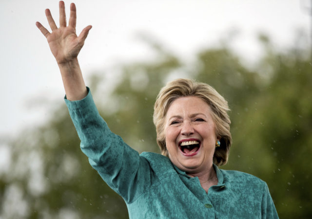 Democratic presidential candidate Hillary Clinton waves as she cuts her speech short due to rain at a rally at C.B. Smith Park in Pembroke Pines, Fla., Nov. 5, 2016. (AP)