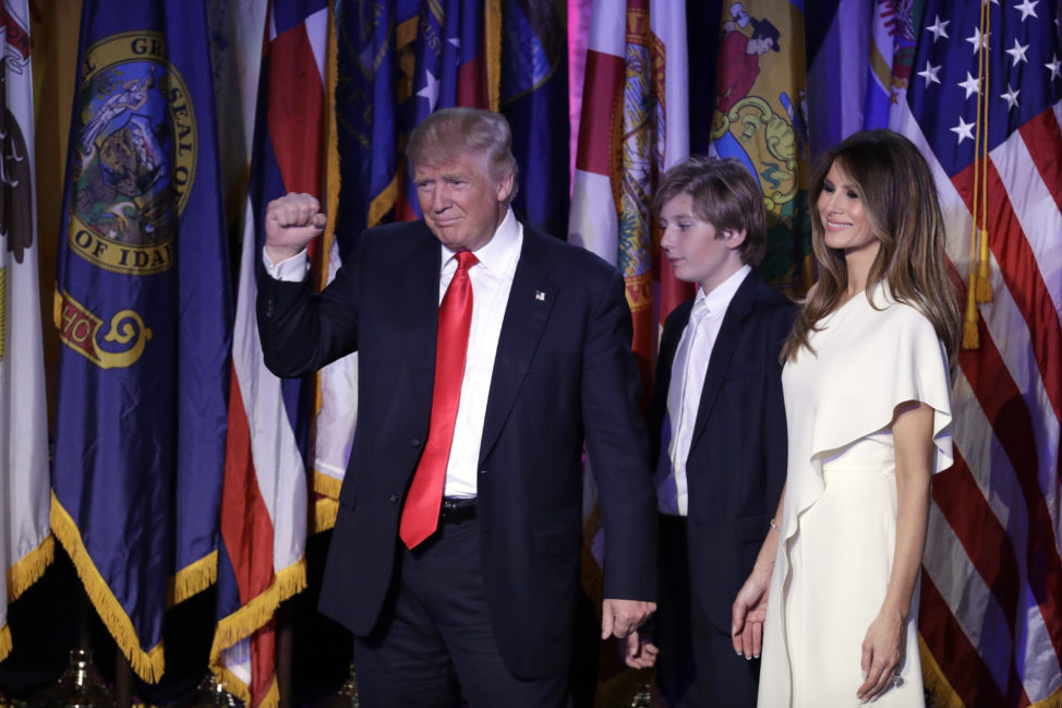 President-elect Donald Trump pumps his fist after giving his acceptance speech as his wife Melania Trump, right, and their son Barron Trump follow him during his election night rally, Nov. 9, 2016, in New York. (AP)