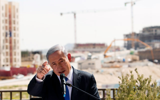 Israeli Prime Minister Benjamin Netanyahu delivers a statement in March 2015, in front of a new construction, in the Jewish settlement known to Israelis as Har Homa and to Palestinians as Jabal Abu Ghneim, in an area of the West Bank that Israel captured in a 1967 war and annexed to the city of Jerusalem. (Reuters) 