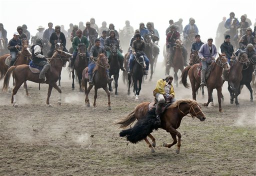 Tajiks horse riders play "buzkashi" during a competition as part of Navruz festivities near Dushanbe, Tajikistan, Tuesday, March 22, 2011. Navruz is a spring festival celebrated around equinox in Iran, Central Asia and the Caucasus. Banned in the Communist era, the festival enjoys a revival in ex-Soviet states. (AP Photo/Theodore Kaye)